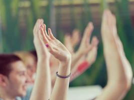 students group raise hands up on class photo