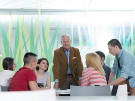 portrait of in teacher in classroom with students group in background photo