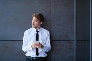 startup businessman in a white shirt with a tie using mobile phone photo