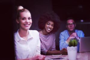 Multiethnic startup business team in night office photo