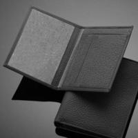 un primer plano de una billetera de cuero de moda sobre un fondo oscuro foto