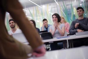 teacher with a group of students in classroom photo