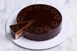 A top view shot of a chocolate cake on a white plate photo