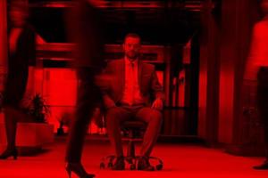 business man sitting in office chair, people group  passing by photo