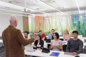 teacher with a group of students in classroom photo