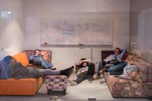 software developers sleeping on sofa in creative startup office photo