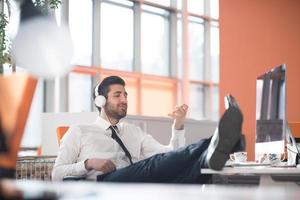 relaxed young business man at office photo