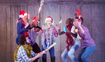 multiethnic group of casual business people dancing with sparklers photo