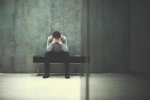 businessman using smart phone while sitting on the bench photo