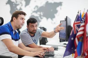 two male software developers working on computer