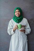 african muslim businesswoman with green hijab using mobile phone photo