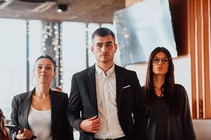 Group of successful business people standing together at office. photo