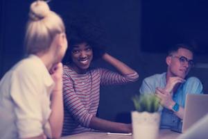 Multiethnic startup business team in night office photo