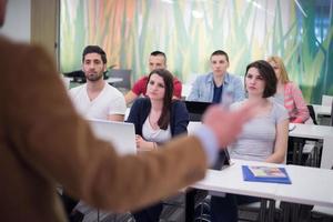 teacher with a group of students in classroom photo