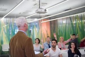 teacher with a group of students in classroom photo