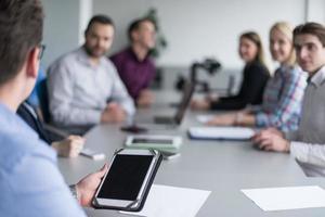 Businessman using tablet in modern office photo