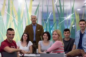 portrait of  teacher with students group in background photo