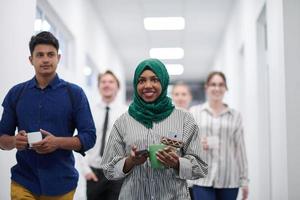 multi-ethnic startup business team walking through the hallway photo