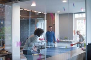 startup business team playing ping pong tennis photo