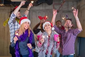 multiethnic group of casual business people dancing with sparklers photo