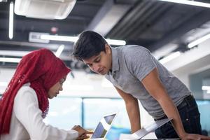 black muslim business woman having a meeting with her indian male colleague photo