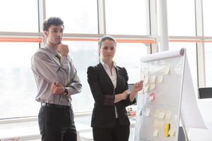 young couple working on flip board at office photo