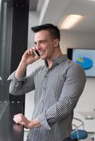 young business man speaking on  smart phone at office photo