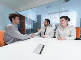 young couple signing contract documents on partners back photo