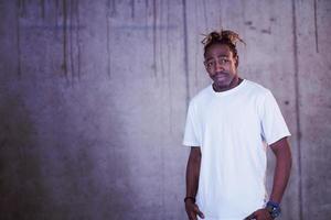 portrait of black businessman in front of a concrete wall photo