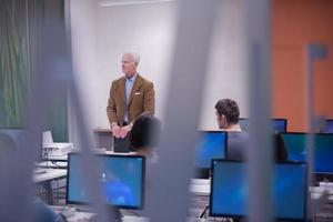 teacher and students in computer lab classroom photo