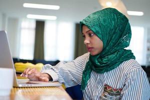 african muslim business woman working on laptop computer photo