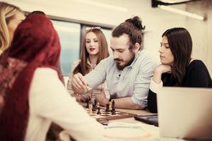 multiethnic group of business people playing chess photo