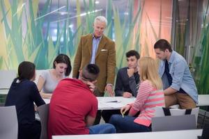 teacher with a group of students in classroom photo