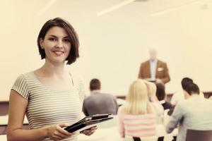 portrait of happy female student in classroom photo