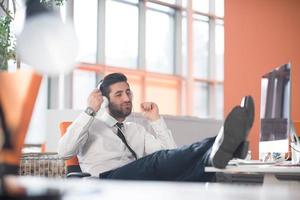 relaxed young business man at office photo