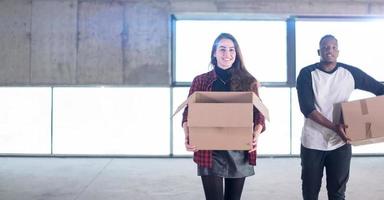 multiethnic business team carrying cardboard boxes photo