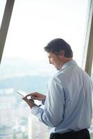 handosme business man working on tablet photo