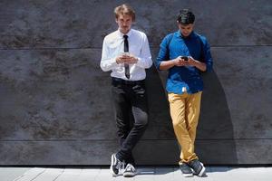 casual multiethnic startup business men using mobile phone photo