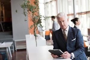 senior business man working on tablet computer photo