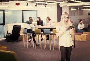 blonde businesswoman working online using digital tablet photo