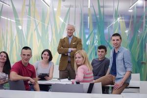 portrait of  teacher with students group in background photo