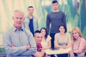 portrait of  teacher with students group in background photo