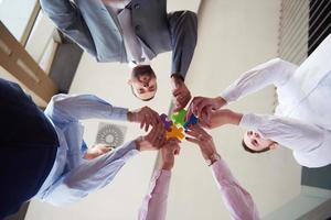 business people group assembling jigsaw puzzle photo