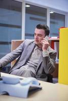 business man talking by phone in office photo