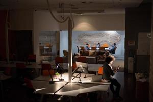 man working on computer in dark office photo