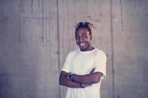 portrait of black businessman in front of a concrete wall photo