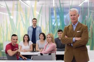 portrait of  teacher with students group in background photo