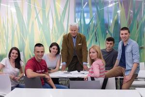 portrait of  teacher with students group in background photo