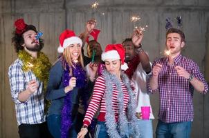 multiethnic group of casual business people dancing with sparklers photo