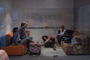 software developers sleeping on sofa in creative startup office photo